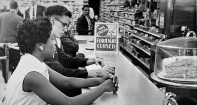 Gwendolyn Greene (later Britt) sits patiently at the People’s Drug counter in Arlington, Virginia during a sit-in protest June 9, 1960. (Photo by Paul Schmick. Courtesy of the D.C. Public Library Washington Star Collection © Washington Post.)