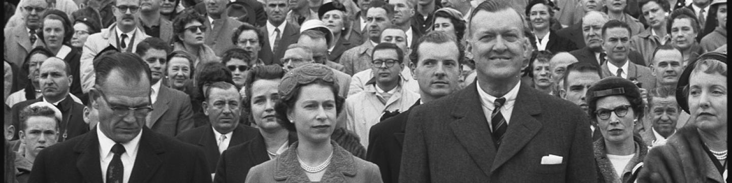 Queen Elizabeth II with Maryland governor Theodore McKeldin (right) and University of Maryland president Wilson Homer "Bull" Elkins (left), at a Maryland Terrapins vs. the North Carolina Tar Heels football game in College Park, Maryland on October 19, 1957. (Source Library of Congress)